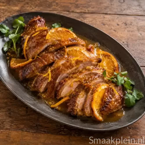 Geroosterde eend met warme sinaasappelsaus, sinaasappelschil en waterkers
